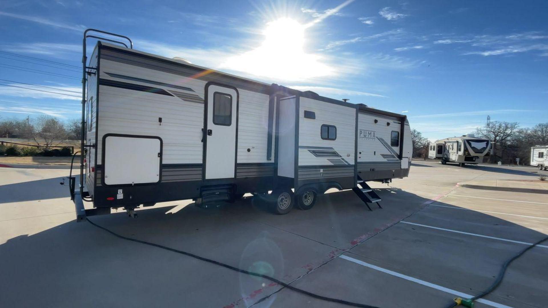 2023 FOREST RIVER PUMA 32BH2B (4X4TPUH21PP) , Length: 38.5 ft. | Dry Weight: 9,023 lbs. | Gross Weight: 11,230 lbs | Slides: 3 transmission, located at 4319 N Main St, Cleburne, TX, 76033, (817) 678-5133, 32.385960, -97.391212 - With its ample space and adaptability, the 2023 Palomino Puma 32BH2B travel trailer is perfect for hosting extended families and gatherings. This model provides generous living space while maintaining excellent maneuverability on the road. It measures 38.5 feet in length and has a dry weight of 9,02 - Photo#1