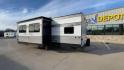 2024 KEYSTONE ASPEN TRAIL 29BH (4YDTATN23R8) , Length: 33.25 ft | Dry Weight: 6,484 lbs | Slides: 1 transmission, located at 4319 N Main St, Cleburne, TX, 76033, (817) 678-5133, 32.385960, -97.391212 - This used Keystone Aspen Trail 29BH is a well-maintained travel trailer with a modern and stylish exterior. Its silver and dark gray aluminum siding gives it a sleek, clean appearance, with white accents and a well-defined design pattern along the sides. It is equipped with multiple windows, enhanci - Photo#7