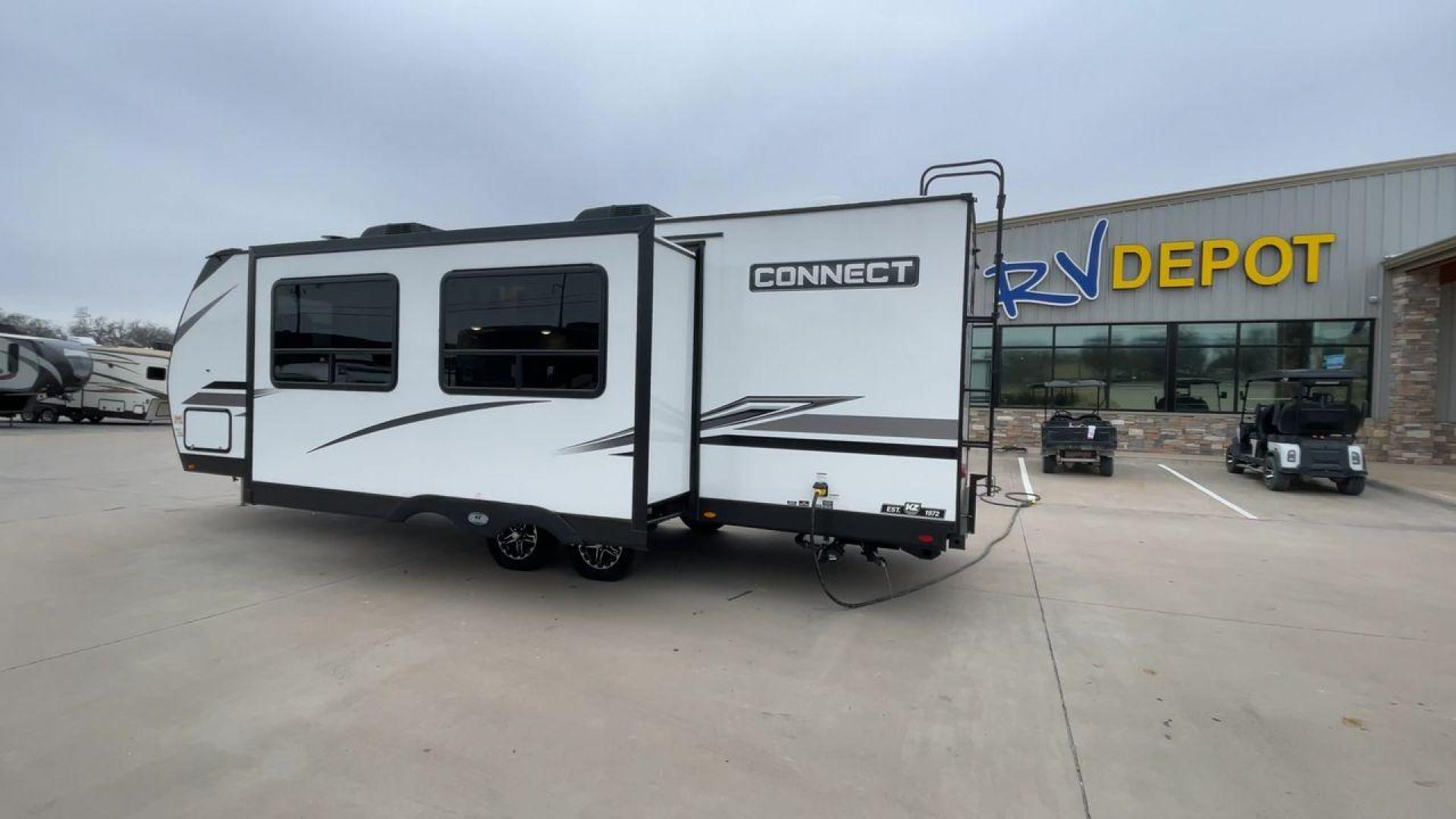 2024 KZ CONNECT 261RB (4EZTL2721R7) , Length: 30.33 ft | Dry Weight: 6,460 lbs | Gross Weight: 7,345 lbs | Slides: 1 transmission, located at 4319 N Main St, Cleburne, TX, 76033, (817) 678-5133, 32.385960, -97.391212 - At 30.33 ft long, the 2024 KZ Connect 261RB is a modern and stylish travel trailer with a sleek and aerodynamic design. Its white fiberglass exterior is accented with black and gray geometric decals, giving it a sharp and contemporary look. The front cap is painted black with the CONNECT branding pr - Photo#7