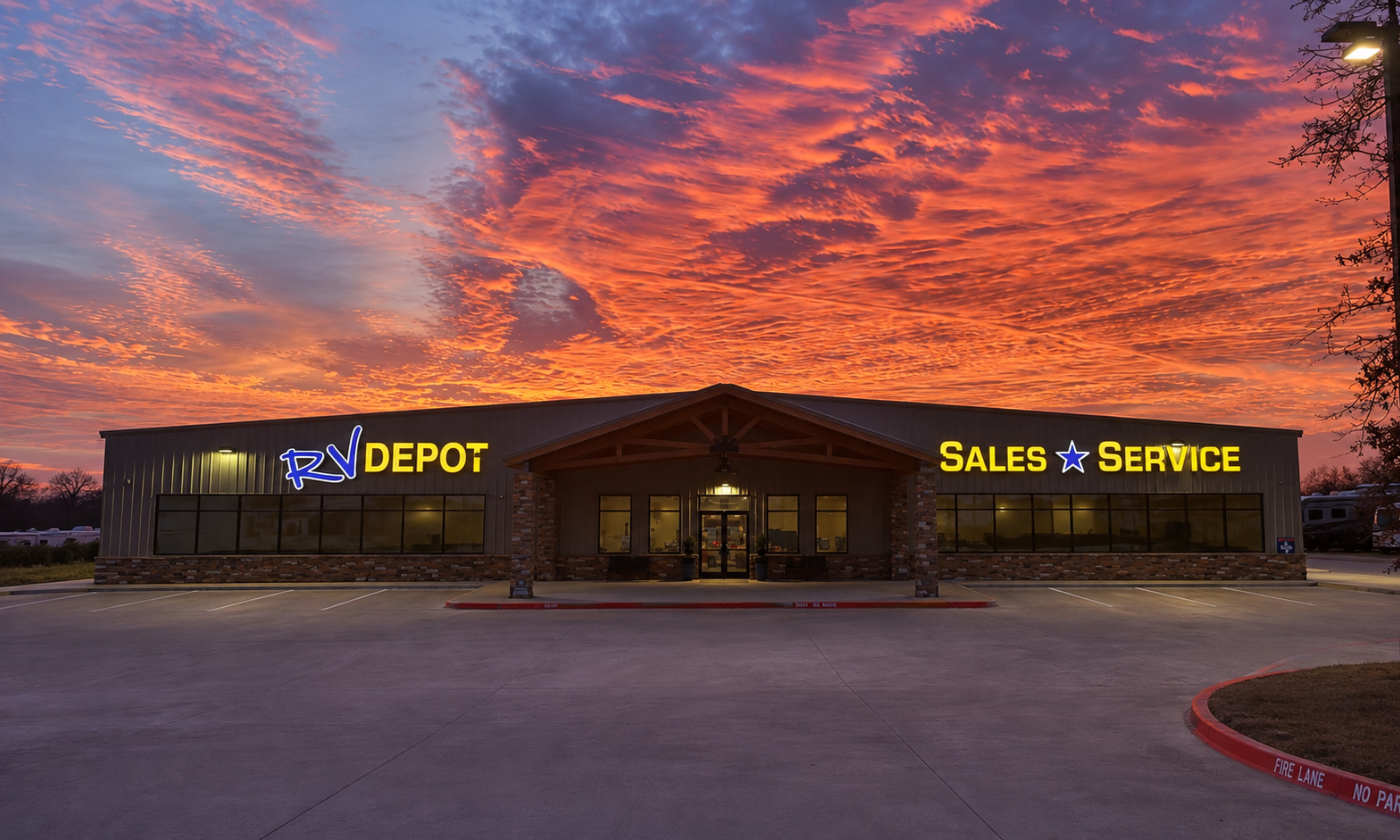 An RV parked under a Texas sunset with warm interior lights glowing