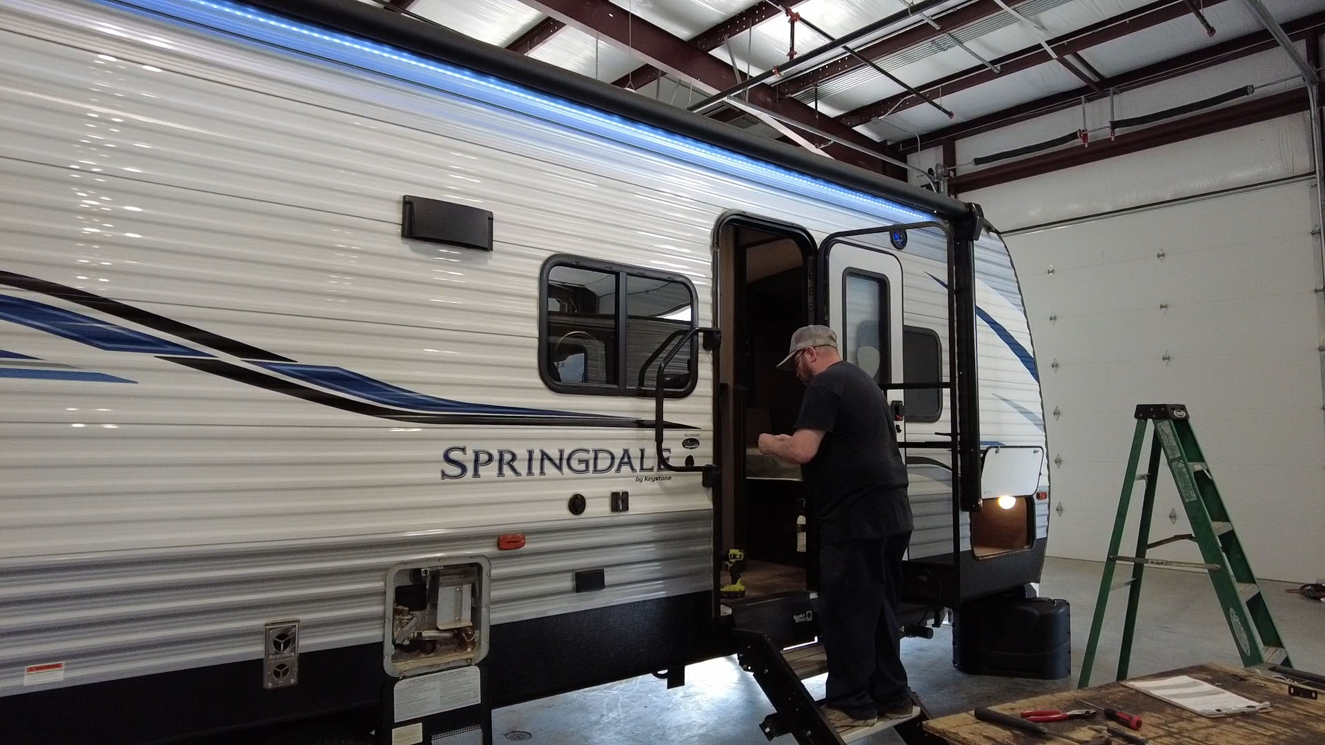 Man stepping inside the tailer for repairs