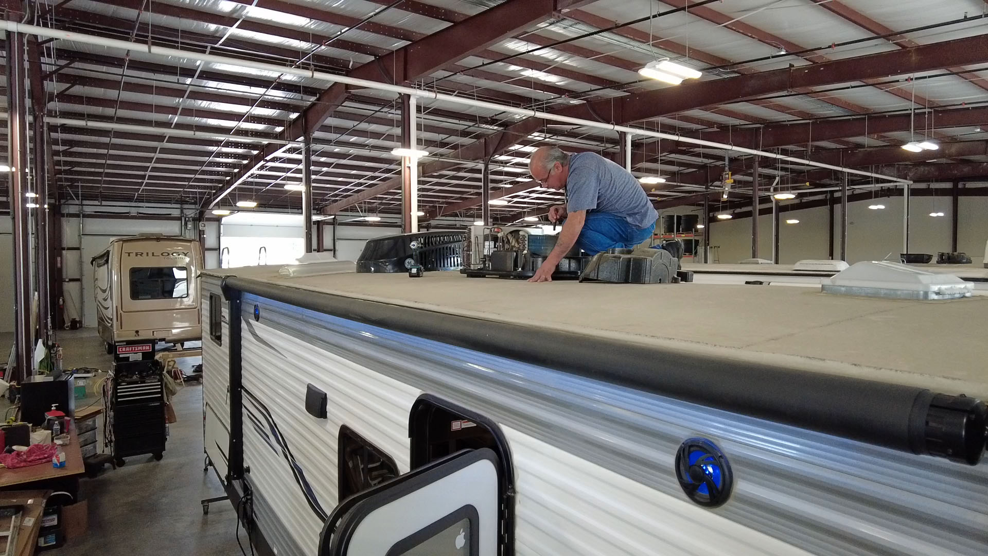 Man doing repairs on a RV Roof